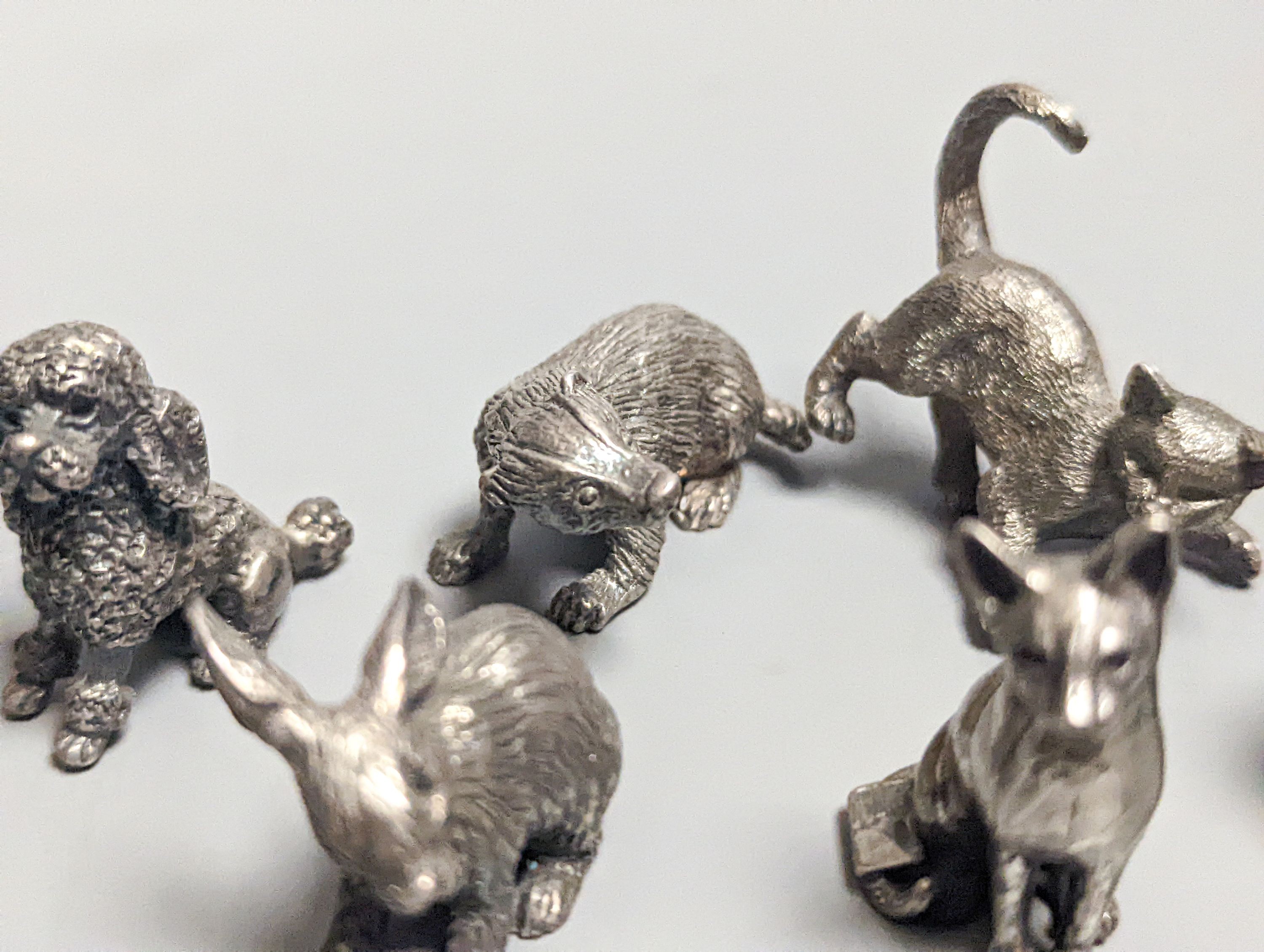 Four modern miniature freestanding model animals, including, badger, two dogs and a cat, JJSM, London, 1989 &1991, cat length 37mm, two Italian 925 models and two base metal models.